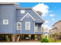 Elevated blue house with parking underneath, offering unique features at 902 Sea Mountain Hwy. # 10, North Myrtle Beach, SC 29582