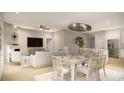 Open concept dining area with seating for six and a modern chandelier at 546 Beckham Ct., Murrells Inlet, SC 29576