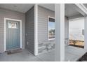 Inviting front porch with light gray siding and a teal door at 552 Beckham Ct., Murrells Inlet, SC 29576