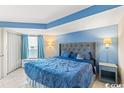 King-size bed in a condo with blue walls and tiled floors at 1501 S Ocean Blvd. # 1548, Myrtle Beach, SC 29577