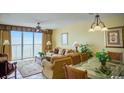Living room with ocean view, comfortable seating, and dining area at 1625 S Ocean Blvd. S # 909, North Myrtle Beach, SC 29582