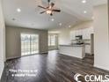 Open living room with kitchen and sliding glass doors at 2819 Biscane Ct., Conway, SC 29527