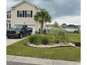 Two-story house with palm trees and landscaped yard at 219 Oak Leaf Dr., Longs, SC 29568