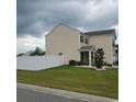 Two-story house with backyard patio and white fence at 219 Oak Leaf Dr., Longs, SC 29568