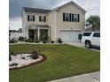 Two-story house with landscaped yard and attached garage at 219 Oak Leaf Dr., Longs, SC 29568