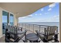 Ocean view balcony with chairs and a table at 603 S Ocean Blvd. # 1011, North Myrtle Beach, SC 29582