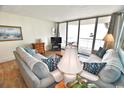 Living room features ocean view, comfy sofas, and tiled floors at 1012 N Waccamaw Dr. # 103, Garden City Beach, SC 29576