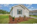 Exterior view of a light gray house with a blue door and white garage door at 415 Bearskin Ct., Longs, SC 29568