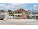 Two-story brick home with street view and neighboring houses at 1418 S Ocean Blvd., North Myrtle Beach, SC 29582