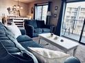 Living room with comfortable sofas and access to a balcony at 5905 S Kings Hwy. # 337B, Myrtle Beach, SC 29575