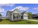 Gray siding two-story house with landscaping at 1906 Woodrush Loop, Little River, SC 29566