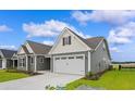 Gray siding two-story house with a two-car garage at 1906 Woodrush Loop, Little River, SC 29566