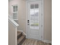 Front entry with white door and carpeted stairs at 1906 Woodrush Loop, Little River, SC 29566