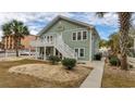 Two-story house with a green exterior, deck, and landscaping at 1906 S Ocean Blvd., North Myrtle Beach, SC 29582