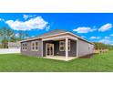 Gray house with covered patio and backyard at 108 Little Cedar Dr., Loris, SC 29569