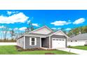 Gray house with white garage door and landscaping at 108 Little Cedar Dr., Loris, SC 29569