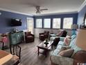 Living room with light gray floors, blue walls, comfy seating at 5905 South Kings Hwy. # 6110-D, Myrtle Beach, SC 29575