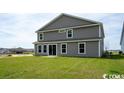 Rear view of two-story house with gray siding at 263 Lassoed Circle, Murrells Inlet, SC 29576