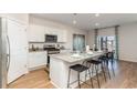 Modern kitchen with white cabinets, granite countertops, and stainless steel appliances at 711 Canton St., Conway, SC 29526