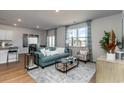 Open living room with teal couch, coffee table, and access to the kitchen at 711 Canton St., Conway, SC 29526