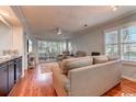 Bright living room with hardwood floors and sliding glass doors at 9550 Dunes Gable Dr. # C, Myrtle Beach, SC 29572