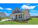 Two-story craftsman style home with neutral siding, stone accents and a two-car garage at 1224 Colusa Ct., Little River, SC 29566