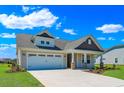 Two-story craftsman style home with neutral siding, stone accents and a two-car garage at 1224 Colusa Ct., Little River, SC 29566