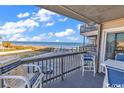 Ocean view balcony with seating for relaxation at 1310 N Waccamaw Dr. # 201, Murrells Inlet, SC 29576