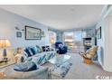 Bright living room with ocean view and comfy seating at 1310 N Waccamaw Dr. # 201, Murrells Inlet, SC 29576