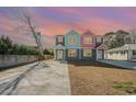 Two-story duplex with gray, teal, and pink exterior, evening view at 503 30Th Ave. N, Myrtle Beach, SC 29577