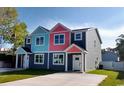 Two-story duplex with gray, teal, and pink exterior, daytime view at 503 30Th Ave. N, Myrtle Beach, SC 29577
