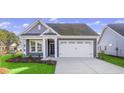 Gray craftsman style home with white garage door and landscaping at 3001 Deerberry Place, Longs, SC 29568