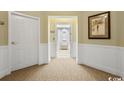 Condo entryway with neutral carpet, white doors, and artwork at 2180 Waterview Dr. # 837, North Myrtle Beach, SC 29582
