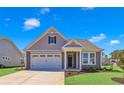 Charming house with gray siding, white trim, and a two-car garage at 1216 Colusa Ct., Little River, SC 29566