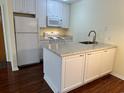 White kitchen with granite countertops and island at 178 Salt Marsh Circle # 30F, Pawleys Island, SC 29585