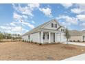 Single-story home with gray siding, white trim, and a two-car garage at 4266 Milkweed Rd., Shallotte, NC 28470