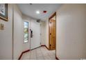 Bright entryway with tile flooring, a white door and stained glass window at 4800 S Ocean Blvd. # 616, North Myrtle Beach, SC 29582
