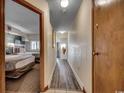 Hallway with light wood laminate flooring, leading to bedrooms at 4800 S Ocean Blvd. # 616, North Myrtle Beach, SC 29582