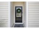 Modern front door with wreath and welcome mat at 1439 Jardine Loop, Little River, SC 29566