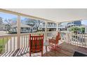 Relaxing porch with rocking chairs and a view of neighboring homes at 6001 - 6011 S Kings Hwy., Myrtle Beach, SC 29575