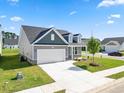 Gray house with a two-car garage and landscaping at 2401 Campton Loop, Conway, SC 29527