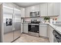 Stainless steel appliances and light gray cabinets in kitchen at 280 Clear Lake Dr., Conway, SC 29526