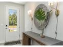 Bright entryway with a console table, mirror, and wall sconces at 133 Fair Meadow Ct., Loris, SC 29569