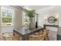 Bright dining room features a rustic table with wicker chairs, offering a casual yet elegant space at 133 Fair Meadow Ct., Loris, SC 29569