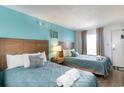 Bedroom with two double beds, teal walls, and wood headboards at 1501 S Ocean Blvd. # 936, Myrtle Beach, SC 29577