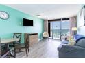Living room with ocean view, light teal walls, and comfy seating at 1501 S Ocean Blvd. # 936, Myrtle Beach, SC 29577