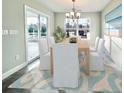 Dining room with light wood table, six chairs, and sliding glass doors at 1424 Nathan Dr., Loris, SC 29569