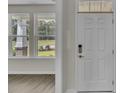 Bright and airy entryway with a view to the backyard and featuring a wood-look floor at 120 Little Cedar Dr., Loris, SC 29569