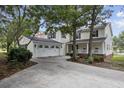 Two-story house with a large garage and a charming front porch at 272 Park St., Little River, SC 29566
