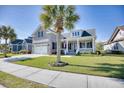 Two-story brick home with front porch and palm trees at 1206 East Isle Of Palms, Myrtle Beach, SC 29579